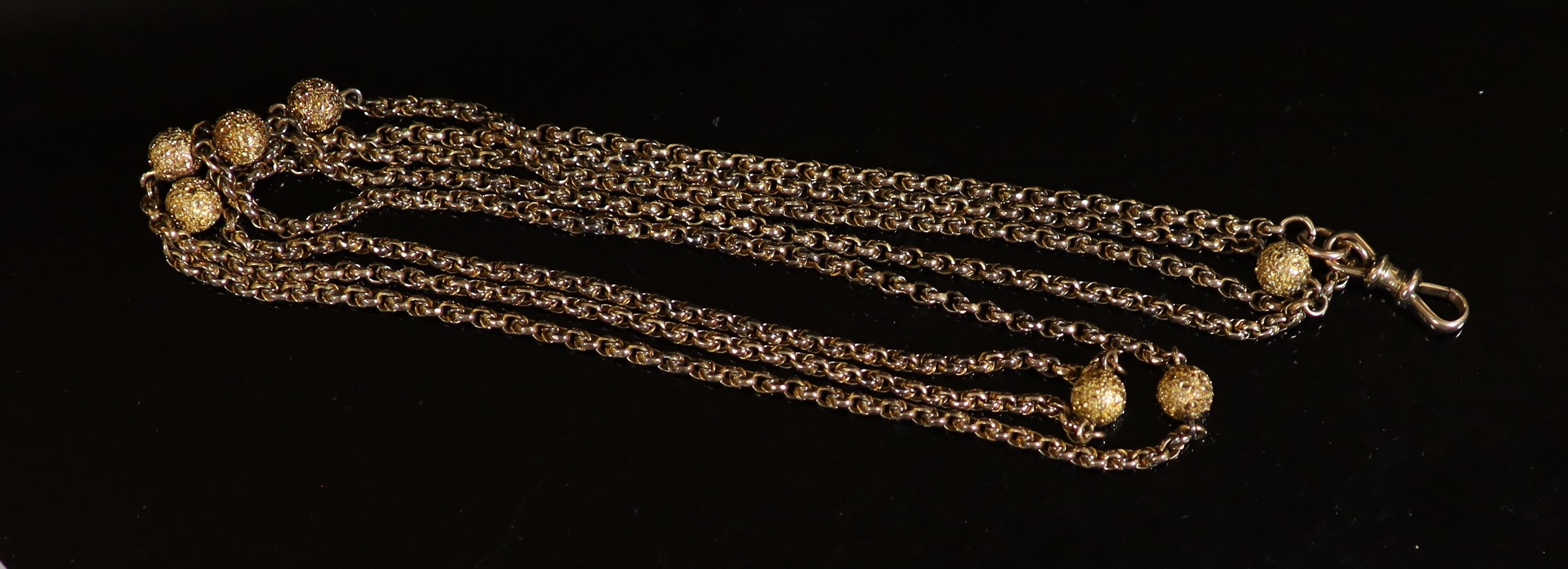 A 19th century 9ct gold guard chain with seven engraved spheres, 124cm